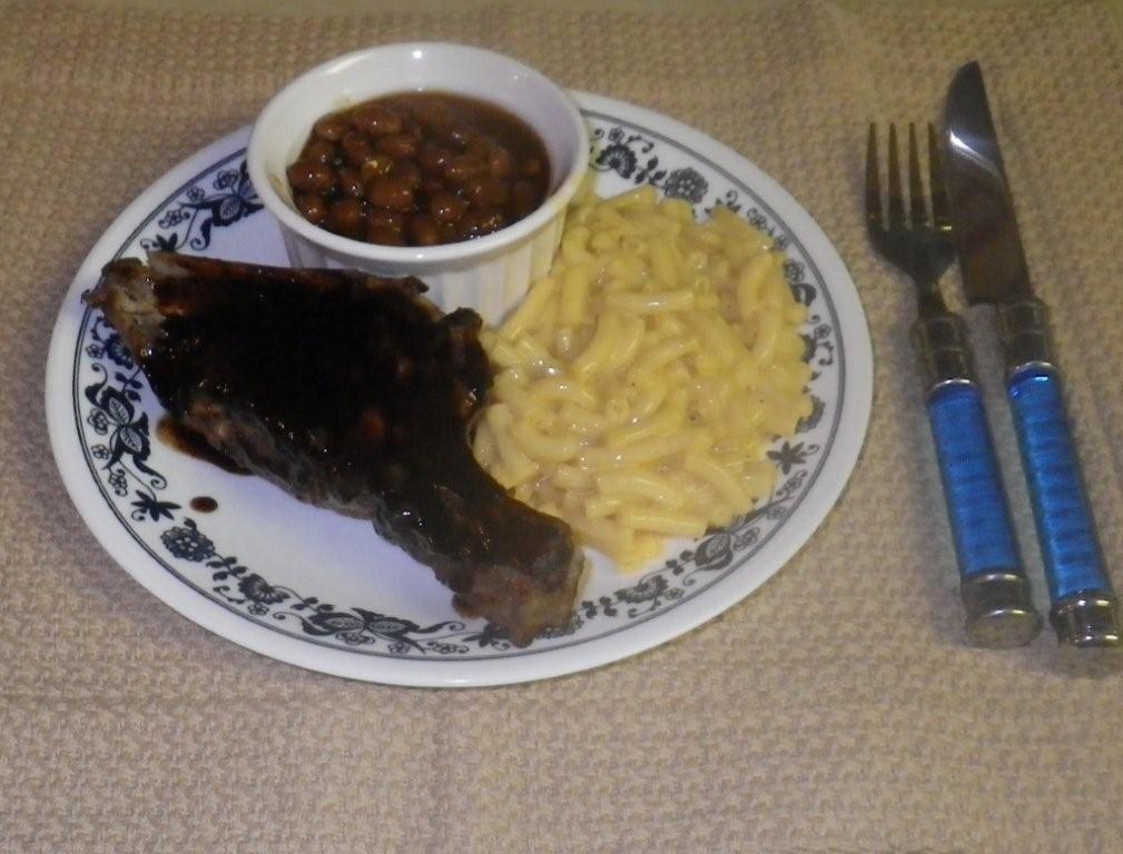 Click to enlarge - Air Core BBQ ribs served with sides of macaroni and cheese and BBQ beans.
