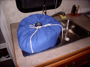Aircore Dutch oven inside cozy and nestled in the RV sink - safe for a drive down the road while dinner cooks and stays hot. 