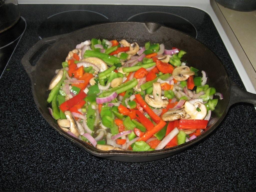 Click to enlarge -  Sweating the vegetables for the lemon lime chicken skillet paella.