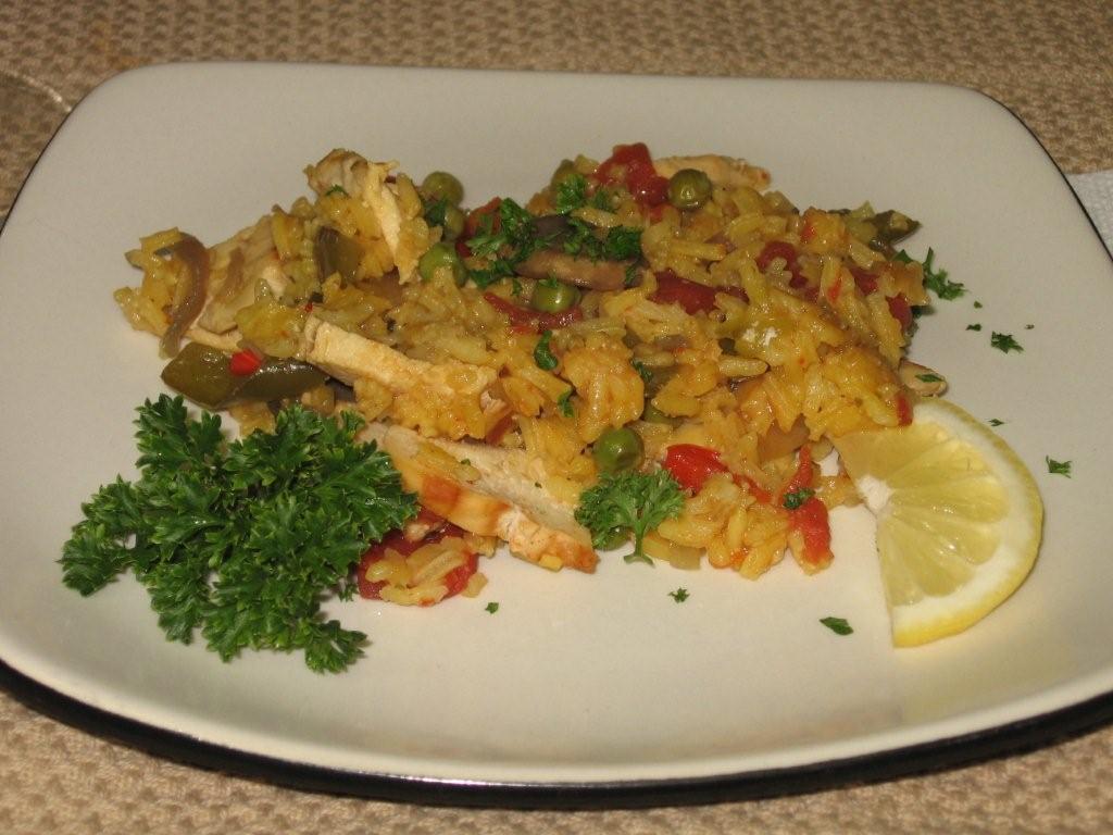 Click to enlarge -  Lemon, lime and white pepper marinated chicken in saffron rice cooked in the manner of a paella.