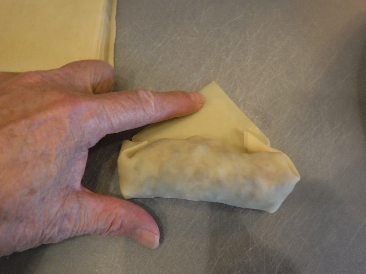 Click to enlarge - Wet the tip of the last flap with water or egg white and roll to seal edges.