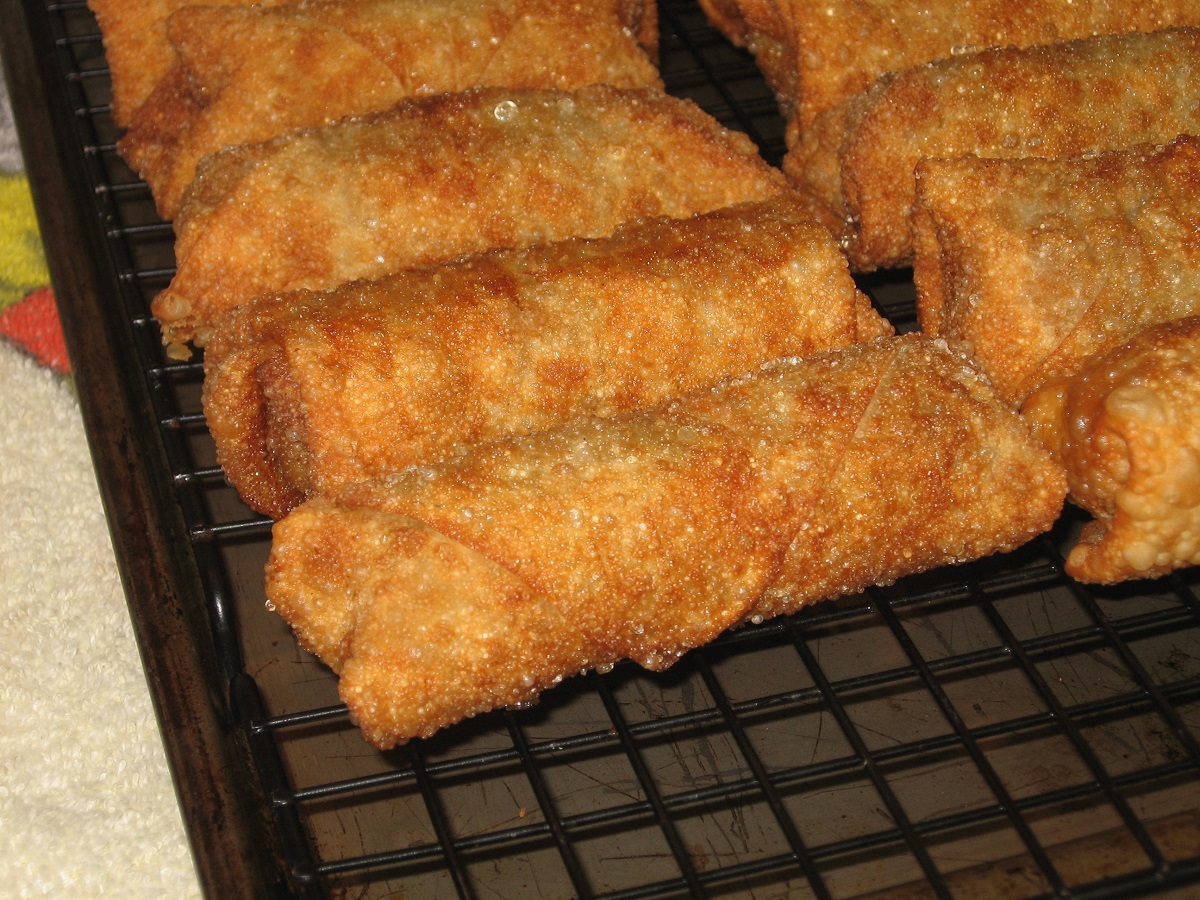 Click to enlarge - Placed cooked egg rolls on a rack to drain.