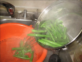 Drain and quench the beans under running cold water.