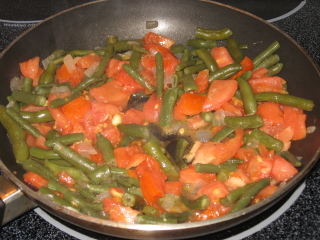 Add tomatoes, cook and stir until heated through.