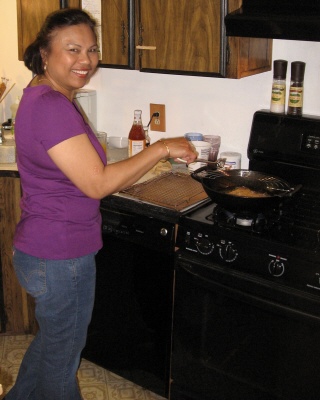 Gloria frying up some of her famous eggrolls in her cast-iron wok.