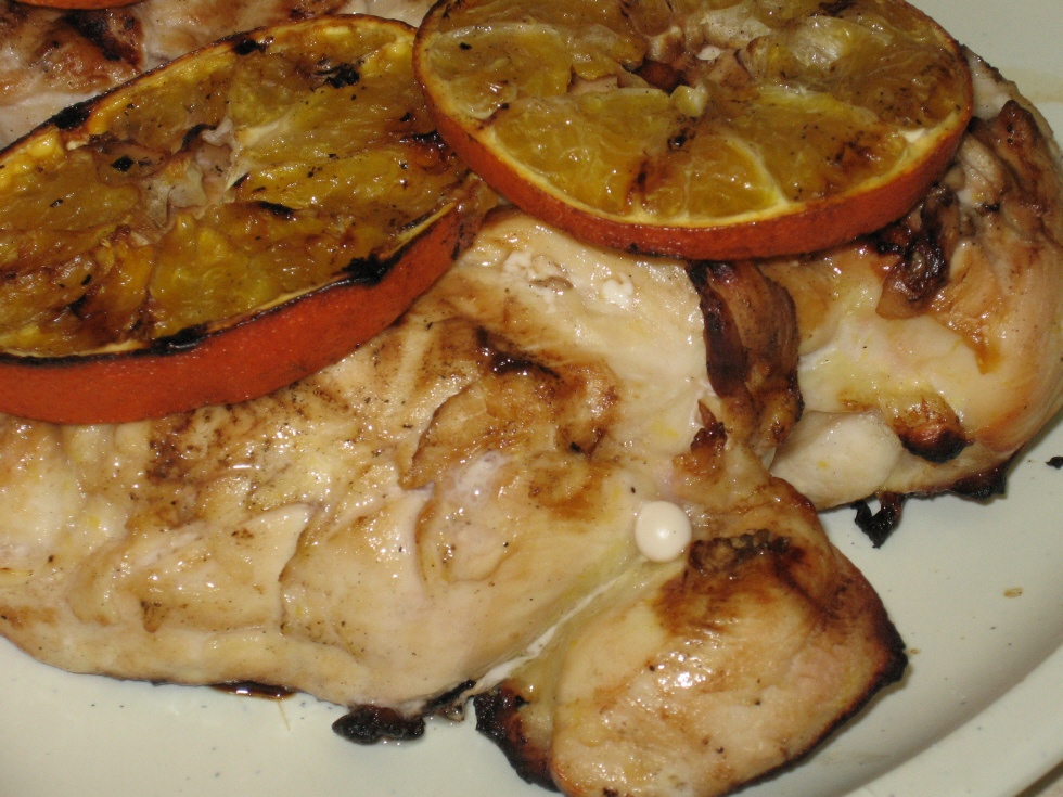 Click to enlarge - Marinated lemon orange chicken served with grilled orange slice garnish.