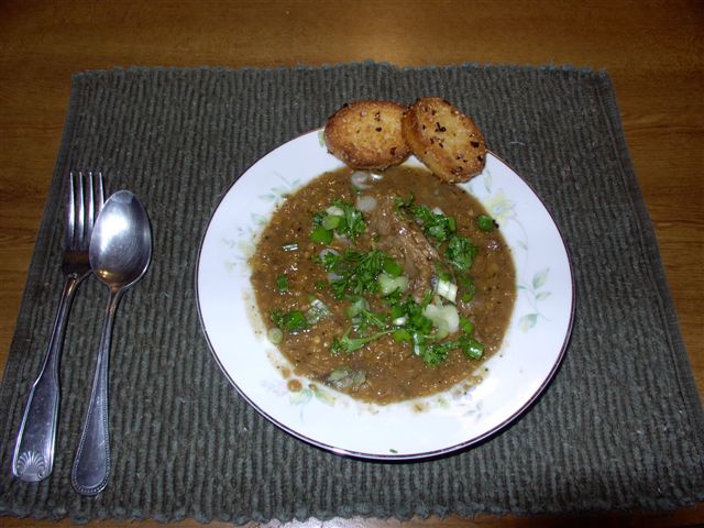 Click to enlarge - Red lentil soup with lamb, garnished with green onions and parsley, served with garlic toast.