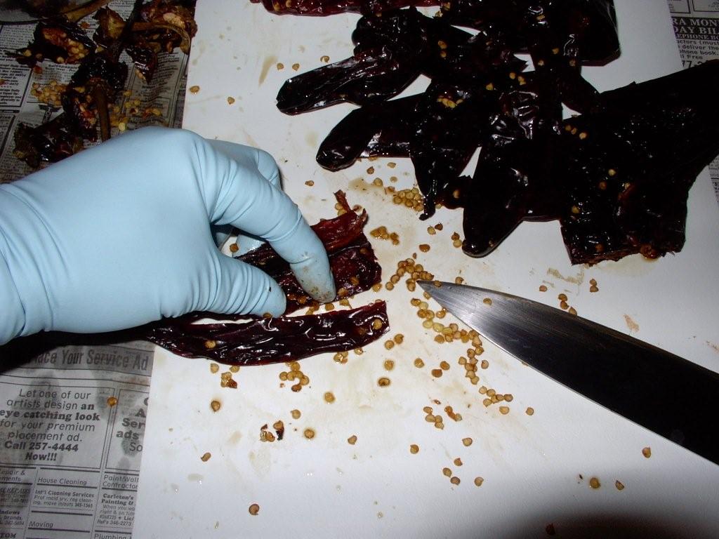 Click to enlarge - Swipe out seeds and pull membrane from inside the chile. Remember to wear gloves.
