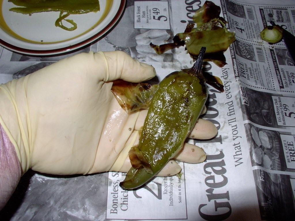 Click to enlarge - When cooled, slide blackened skin off chiles with gloved fingers.