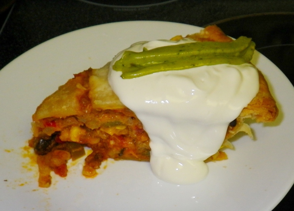 Click to enlarge - Deep Dish Taco Pie with Sour Cream and Guacamole Sauce.