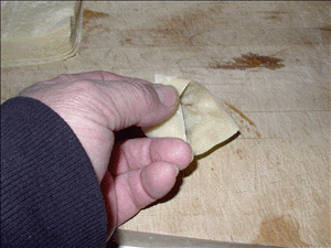 Pull diagonal corner over and an press on the first corner.  