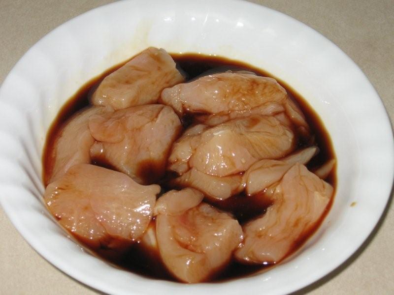 Click to enlarge - Chicken pieces marinating in teriyaki sauce.
